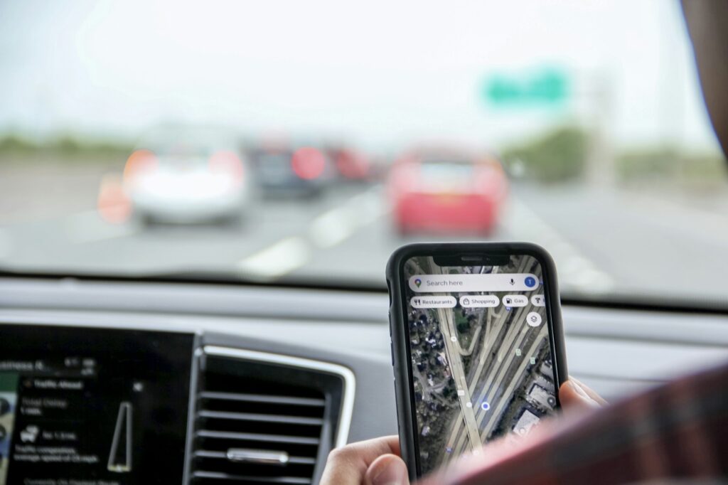 gen z using google map app during road trip in conjunction with vehicle gps for accurate directions